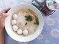 manÃ¢â¬â¹ handÃ¢â¬â¹ holdÃ¢â¬â¹ thaiÃ¢â¬â¹ nooddle withÃ¢â¬â¹ porkÃ¢â¬â¹ ball, onÃ¢â¬â¹ table